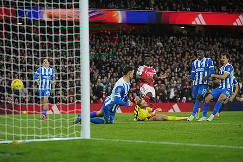 Arsenal vs Brighton & Hove Albion: Arsenal's Bukayo Saka, center, scores his side's second goal during the English League Cup soccer match between Arsenal and Brighton & Hove Albion in London.