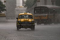 | Photo: PTI/Manvender Vashist Lav : Rainfall in Kolkata: A taxi passes by during rain, in Kolkata, West Bengal.