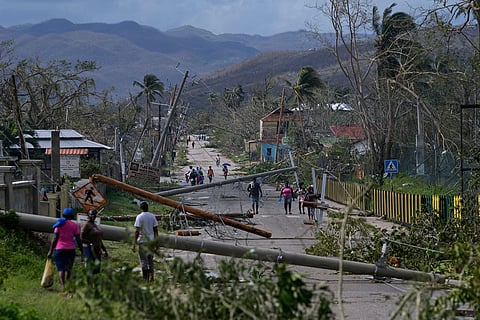 Jamaica Extreme Weather: Residents walk through Lacovia Tombstone, Jamaica, in the aftermath of Hurricane Melissa.