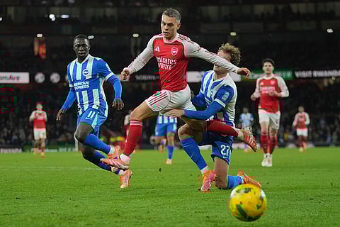 Arsenal vs Brighton & Hove Albion: Arsenal's Leandro Trossard, center, is challenged by Brighton's Mats Wieffer during the English League Cup soccer match between Arsenal and Brighton & Hove Albion in London.
