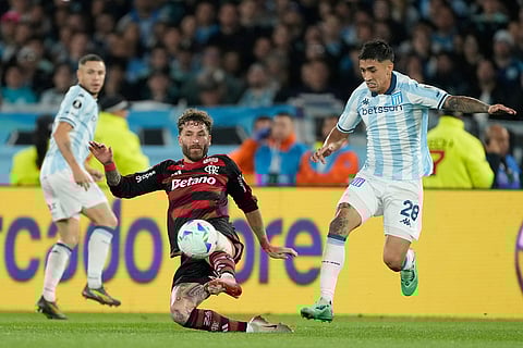 Leo Pereira of Brazil's Flamengo, center, and Santiago Solari of Argentina's Racing Club battle for the ball during a Copa Libertadores semifinal second leg soccer match in Buenos Aires, Argentina.