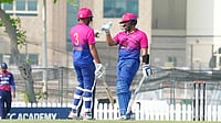 | Photo: X/EmiratesCricket : United Arab Emirates' Aryansh Sharma with Alishan Sharafu during the ICC Cricket World Cup League Two match against Nepal on October 30, 2025.