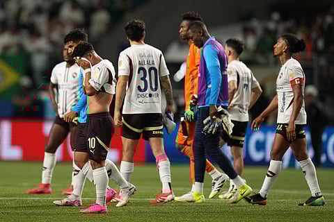 Players of Ecuador's Liga Deportiva Universitaria react at the end of the Copa Libertadores semifinal second leg soccer match against Brazil's Palmeiras in Sao Paulo.