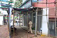 | Photo: PTI : A police official keeps a vigil outside R A Studio, where a man held 19 persons including 17 teenage children hostage yesterday, at Powai area, in Mumbai, Maharashtra.