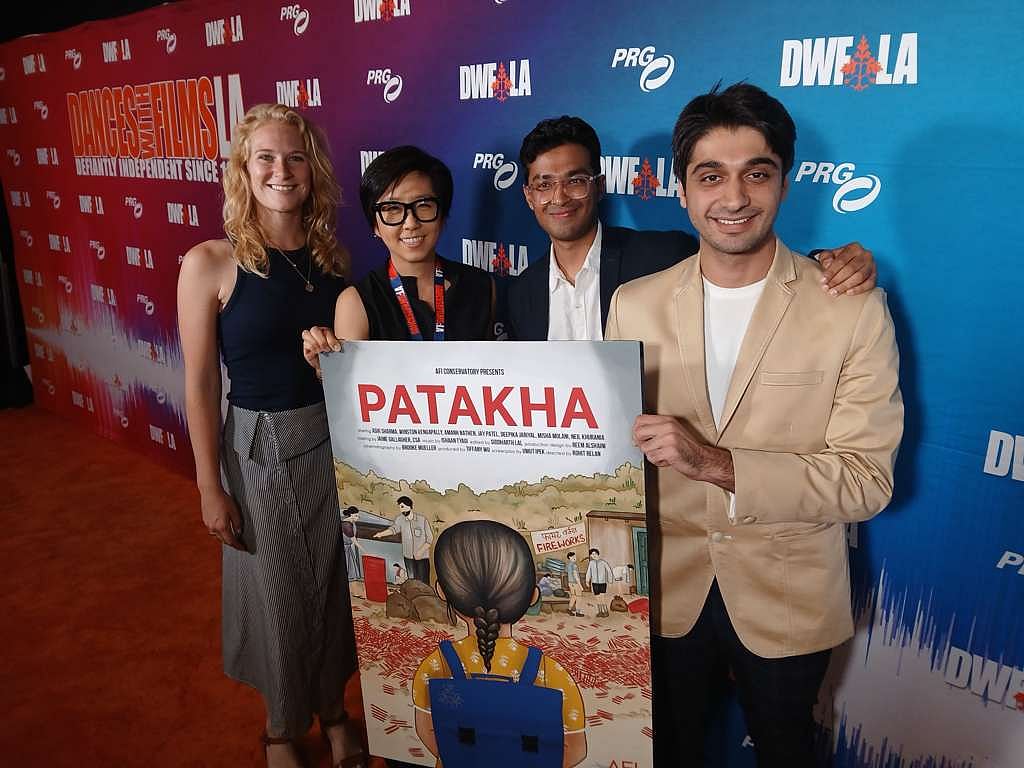 Rohit Relan with three people holding Patakha sign