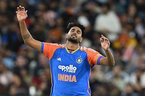 India's Harshit Rana reacts while bowling against Australia during their T20 cricket match in Melbourne, Australia.