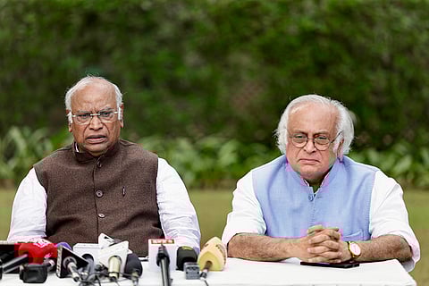 Congress President Mallikarjun Kharge with senior party leader Jairam Ramesh addresses a press conference, in New Delhi. 
