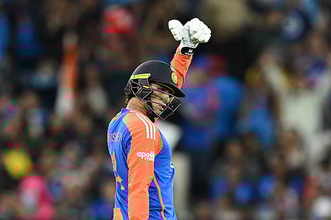 India's Abhishek Sharma celebrates making 50 runs against Australia during their T20 cricket match in Melbourne, Australia.