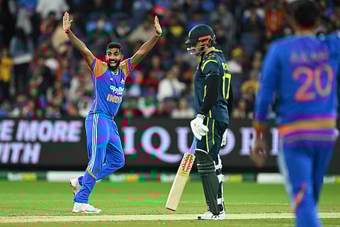 India's Jasprit Bumrah, left, appeals for the wicket of Australia's Mitchell Owen during their T20 cricket match in Melbourne, Australia.