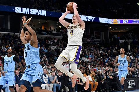Los Angeles Lakers forward Dalton Knecht (4) goes up to shoot over Memphis Grizzlies forward Jaylen Wells (0) in the second half of an NBA Cup basketball game in Memphis, Tenn.