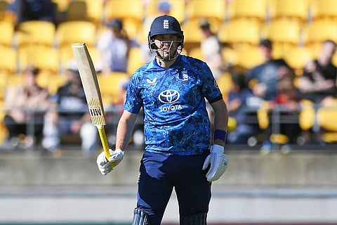 Jamie Overton of England reacts on reaching 50 runs during the One Day International cricket match between New Zealand and England in Wellington, New Zealand.