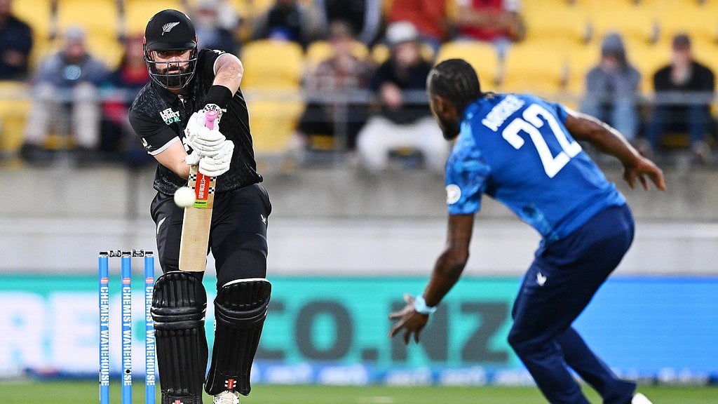 Photo: Kerry Marshall/Photosport via AP                 : Daryl Mitchell of New Zealand plays the ball towards England's Jofra Archer during the third one-day international in Wellington.