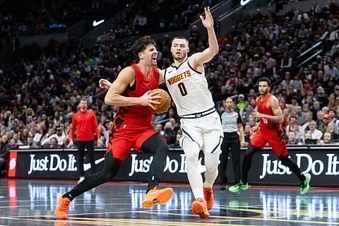 Denver Nuggets guard Christian Braun (0) defends against Portland Trail Blazers forward Deni Avdija, left, during the second half of an NBA Cup basketball game in Portland, Ore.
