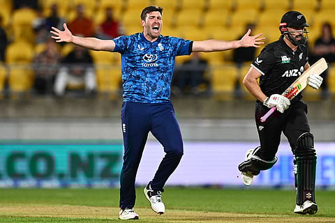Jamie Overton of England appeals unsuccessfully for an LBW against Daryl Mitchell, right, during the One Day International cricket match between New Zealand and England in Wellington, New Zealand.