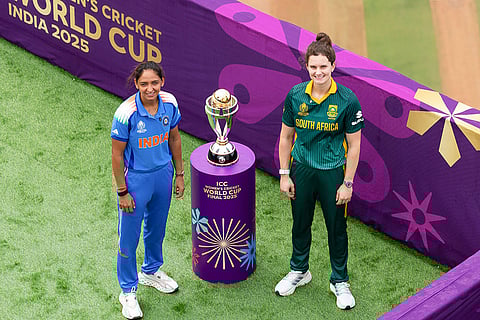 In this image posted on Nov. 1, 2025, India's captain Harmanpreet Kaur and South Africa's captain Laura Wolvaardt pose with the trophy ahead of the ICC Women's World Cup 2025 final cricket match.