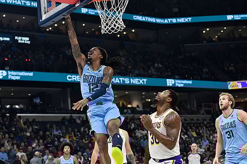 Memphis Grizzlies guard Ja Morant (12) shoots over Los Angeles Lakers guard Marcus Smart (36) in the first half of an NBA Cup basketball game in Memphis, Tenn.