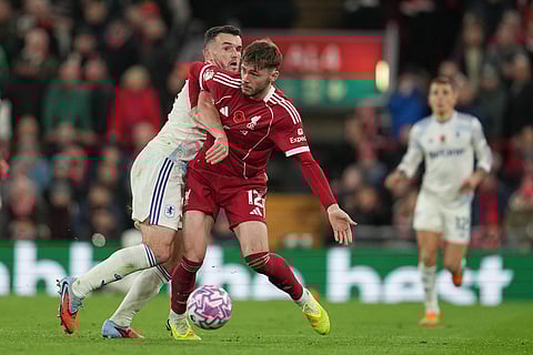 Aston Villa's John McGinn, left, challenges for the ball with Liverpool's Conor Bradley during the English Premier League soccer match between Liverpool and Aston Villa in Liverpool, England.
