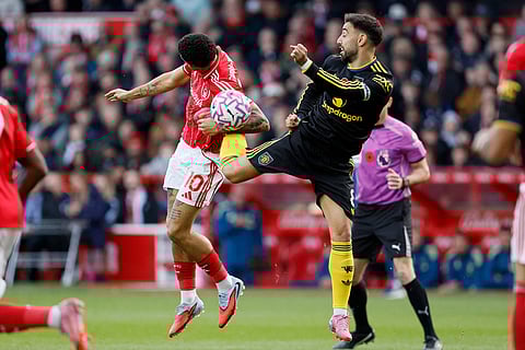 Nottingham Forest's Morgan Gibbs-White, left, and Manchester United's Bruno Fernandes in action during the English Premier League match between Nottingham Forest and Manchester United in Nottingham, England.