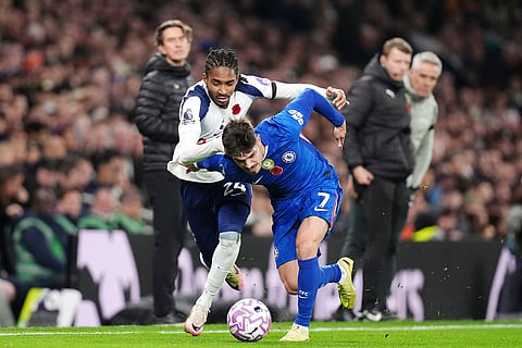 Chelsea's Pedro Neto, left, and Tottenham Hotspur's Djed Spence battle for the ball during the English Premier League soccer match between Tottenham Hotspur and Chelsea in London.