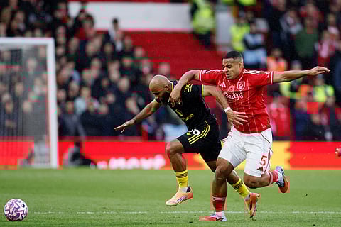 Manchester United's Bryan Mbeumo, left, and Nottingham Forest's Murillo in action during the English Premier League match between Nottingham Forest and Manchester United in Nottingham, England.