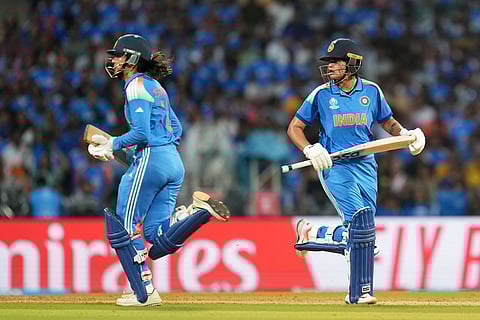 India's Smriti Mandhana, left, and India's Shafali Verma run between the wickets to score during the ICC Women's Cricket World Cup final match between India and South Africa in Navi Mumbai.