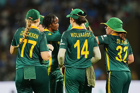 South Africa's Ayabonga Khaka, centre, celebrates the dismissal of India's Shafali Verma with team mates during the ICC Women's Cricket World Cup final match between India and South Africa in Navi Mumbai.