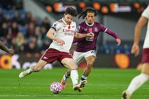 Arsenal's Declan Rice, left, challenges for the ball with Burnley's Hannibal Mejbri during the English Premier League soccer match between Burnley and Arsenal in Burnley, England.

