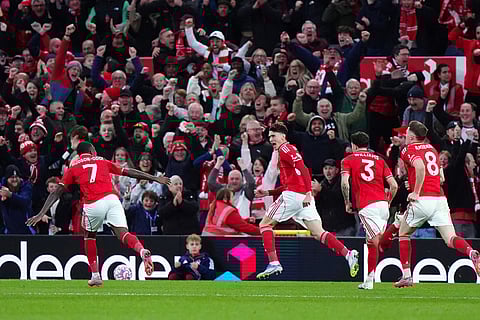Nottingham Forest's Nicolo Savona, second left, celebrates scoring with teammates during the English Premier League match between Nottingham Forest and Manchester United in Nottingham, England.
