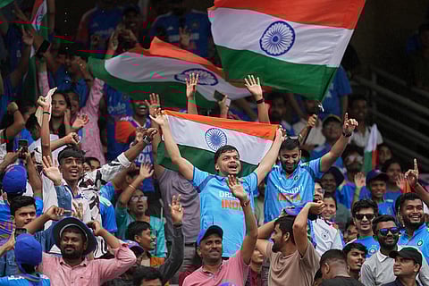 Fans wait as rain delayed the ICC Women's Cricket World Cup final match between India and South Africa in Navi Mumbai.