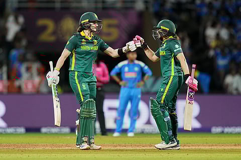 South Africa's captain Laura Wolvaardt, left, celebrates her fifty runs with South Africa's Sune Luus during the ICC Women's Cricket World Cup final match between India and South Africa in Navi Mumbai.
