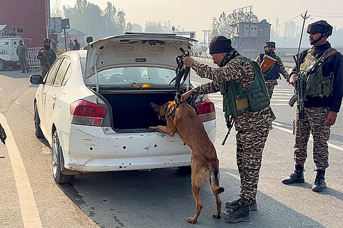 Security personnel frisk vehicles amid 'Darbar Move', in Anantnag.