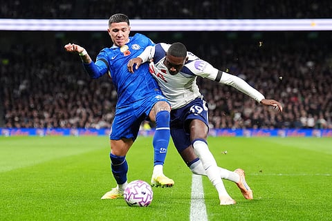 Chelsea's Enzo Fernandez, left, and Tottenham Hotspur's Randal Kolo Muani battle for the ball during the English Premier League soccer match between Tottenham Hotspur and Chelsea in London.