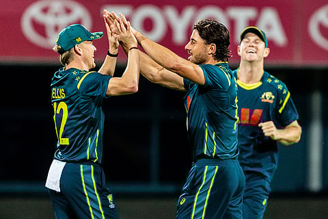Australia's Nathan Ellis, left, celebrates with teammate Marcus Stoinis after taking the wicket of India's Suryakumar Yadav during the T20 cricket international between India and Australia in Hobart.