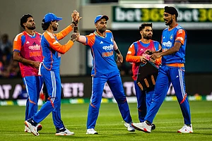 | Photo: Linda Higginson/AAP Image via AP : India players celebrate a wicket during the T20 cricket international between India and Australia in Hobart.