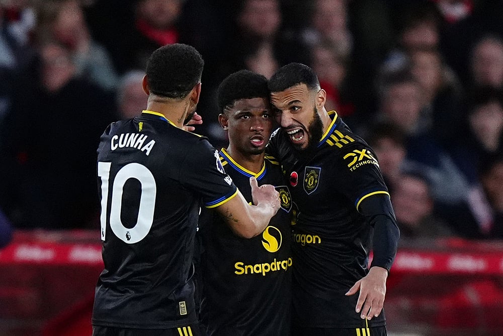 | Photo: Bradley Collyer/PA via AP : Manchester United's Amad Diallo, center, celebrates scoring with teammates Matheus Cunha, left, and Noussair Mazraoui during the English Premier League match between Nottingham Forest and Manchester United in Nottingham, England.