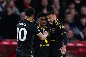 | Photo: Bradley Collyer/PA via AP : Manchester United's Amad Diallo, center, celebrates scoring with teammates Matheus Cunha, left, and Noussair Mazraoui during the English Premier League match between Nottingham Forest and Manchester United in Nottingham, England.