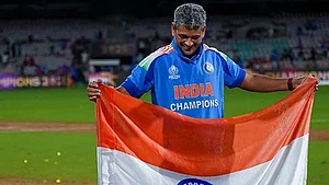 | Photo: PTI/Kunal Patil : India’s coach Amol Muzumdar plants the Indian tricolour on the pitch after the team won the ICC Women's World Cup 2025, at the DY Patil Stadium, in Navi Mumbai.