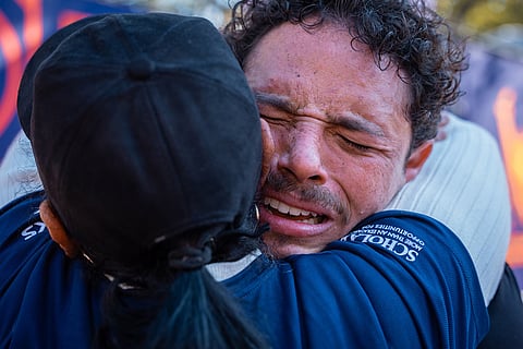 Broadway actor Anthony Ramos cries into his mother Mildred's arms after crossing the finish line of the New York City Marathon in New York. 