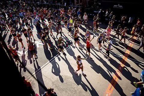 Runners cross the finish line in Central Park at the New York City Marathon in New York. 