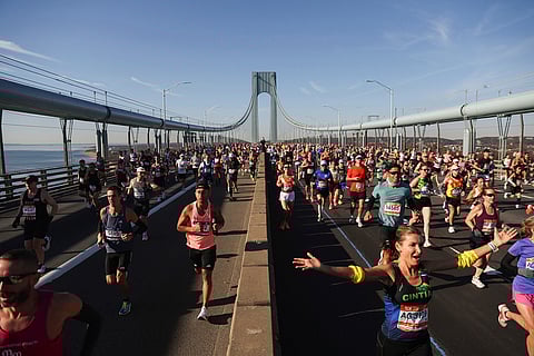 Runners make their way across the Verrazzano Narrows Bridge during the New York City Marathon in New York. 
