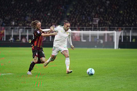 AC Milan's Luka Modric, left, and Roma's Kostas Tsimikas challenge for the ball during the Serie A soccer match between AC Milan and Roma in Milan, Italy.