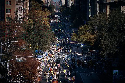 Runners move along First Avenue during the New York City Marathon in New York.