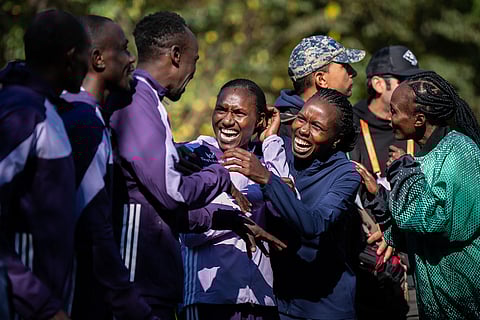The six winners of the men's and women's elite divisions, celebrate together before the medal ceremony after winning the New York City Marathon in New York. 