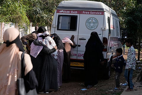 Relatives mourn at the ambulance carrying a victim of the fatal passenger bus accident in Chevella, in southern state of Telangana, India.