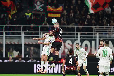 AC Milan's Strahinja Pavlovic, top, and Roma's Bryan Cristante challenge for the ball during the Serie A soccer match between AC Milan and Roma in Milan, Italy.