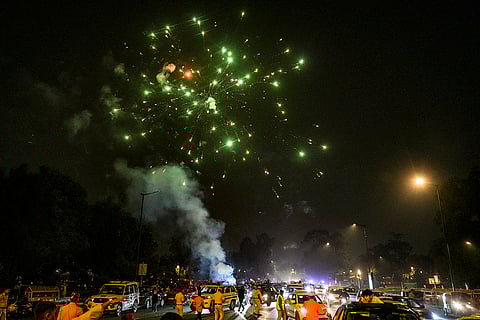 People celebrate after the Indian cricket team won the ICC Women's World Cup 2025, near the India Gate, in New Delhi.