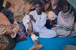 AP Photo/Mohammed Bakry : An injured Sudanese man who fled el-Fasher city, after Sudan's paramilitary forces killed hundreds of people in the western Darfur region, rsits in a tent at a camp in Tawila, Sudan, Friday, Oct. 31, 2025.