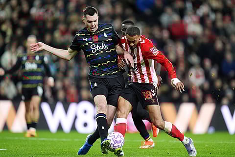 Everton's Michael Keane, left, and Sunderland's Wilson Isidor in action during the English Premier League soccer match between Sunderland and Everton in Sunderland, England.