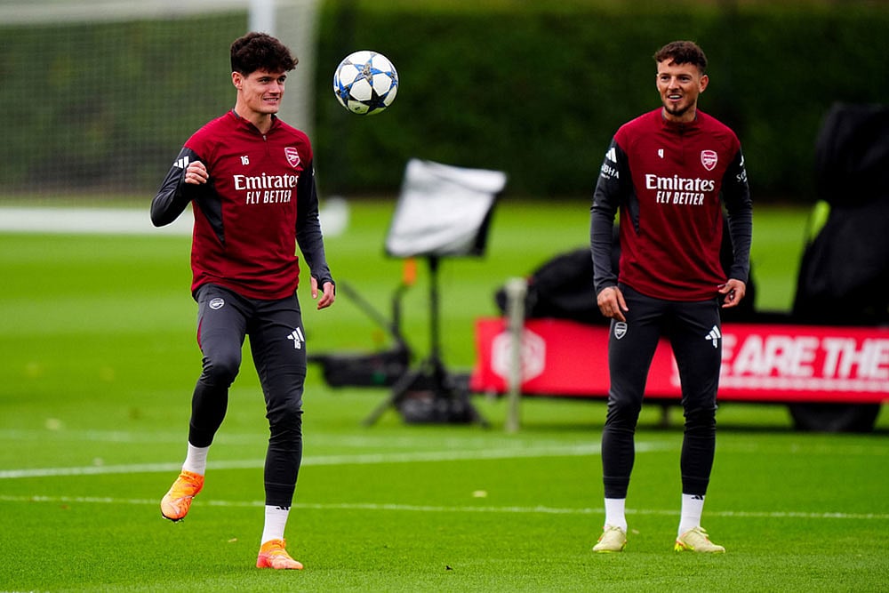 | Photo: Bradley Collyer/PA via AP : Arsenal's Christian Norgaard, left, during a training session in London, England, ahead of the Champions League soccer match against Slavia Praha.