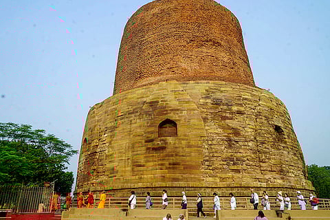 Devotees perform rituals at Dhamek Stupa during the three-day ceremony organised by the Mahabodhi Society of India, at Sarnath in Varanasi.